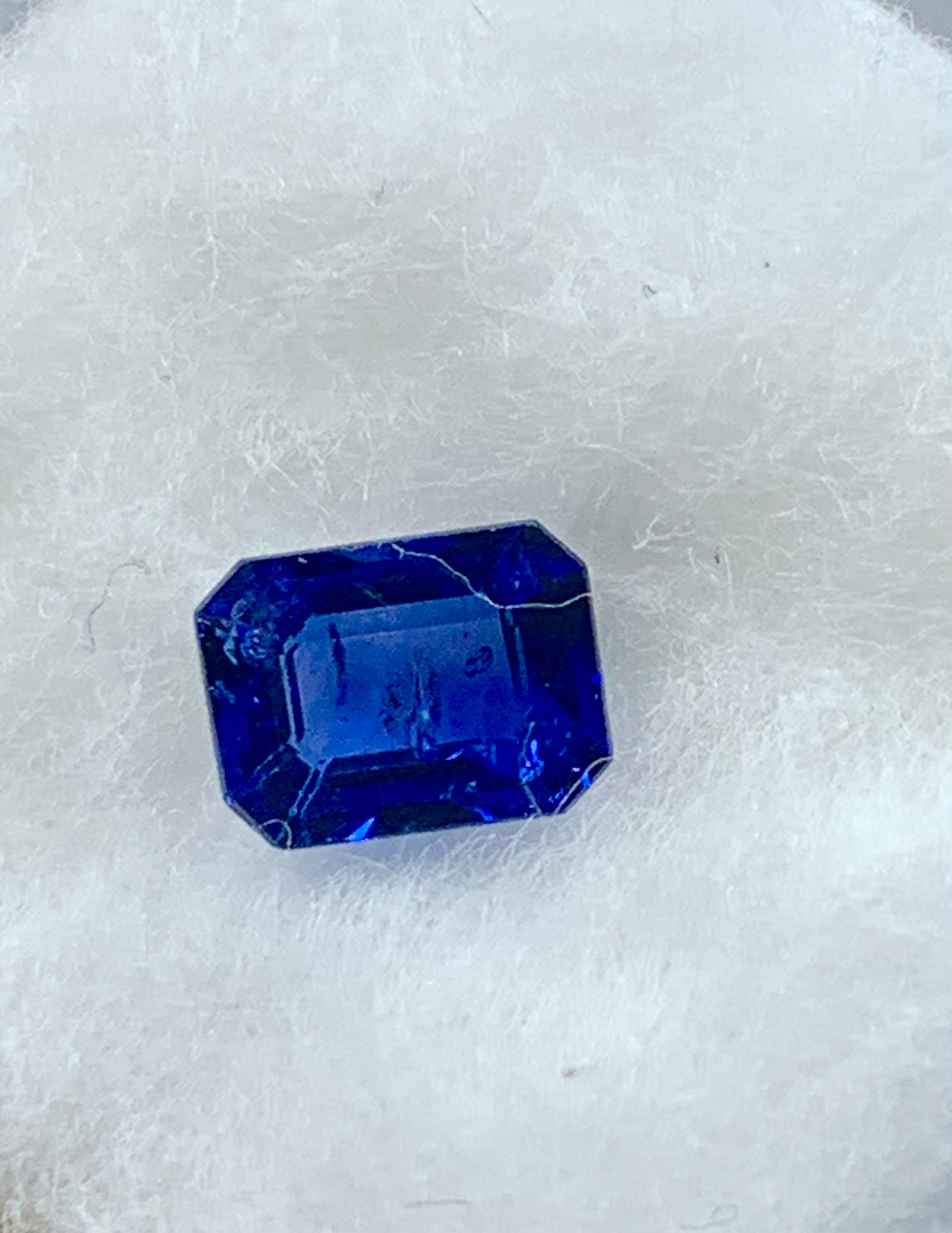 Faceted blue gemstone on a white background