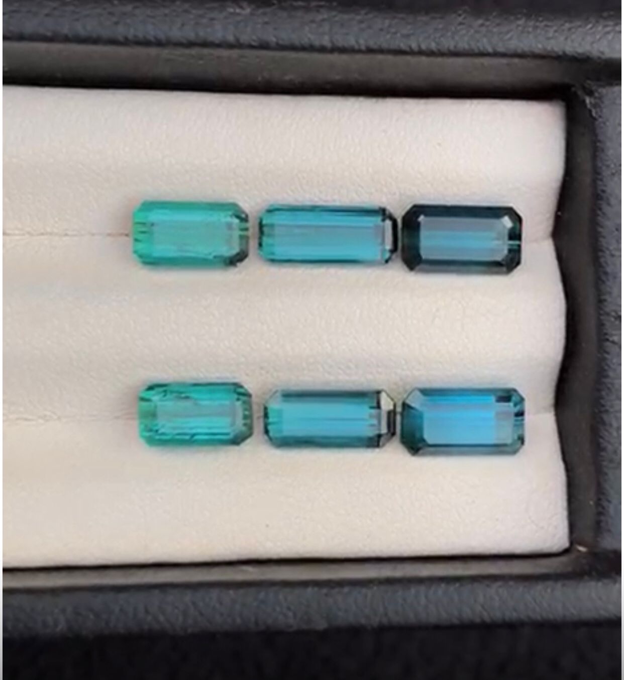 blue loose gemstones in a display case