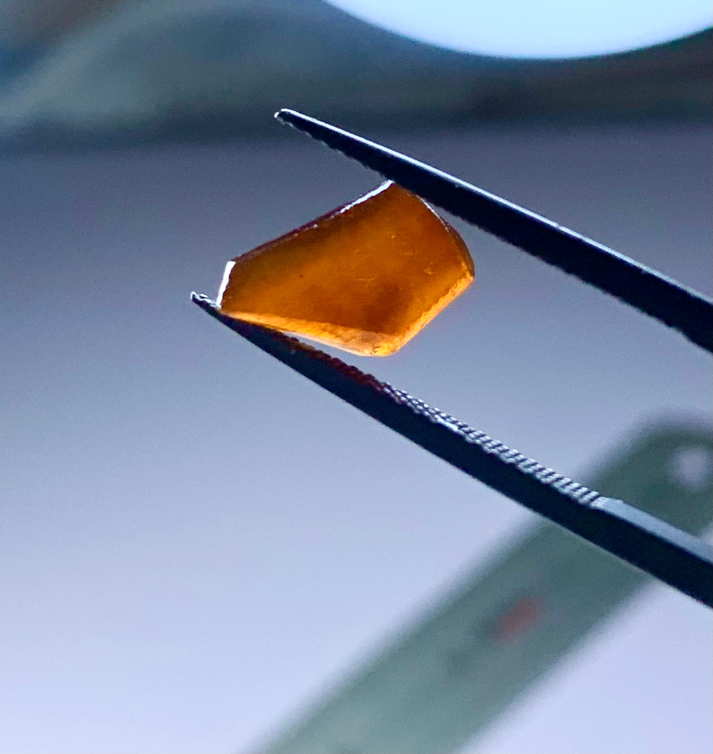 orangish brown hassonite garnet in rough shape