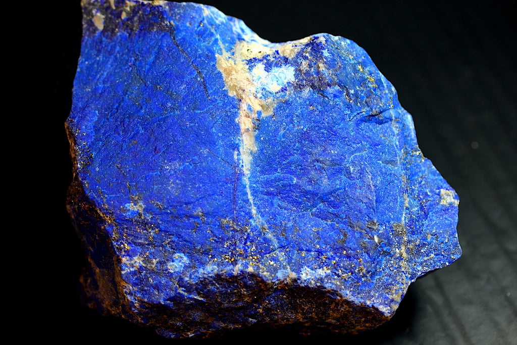 A raw blue lapis lazuli crystal specimen with natural matrix and golden pyrite inclusions